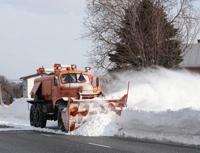 Big truck plowing snow during winter