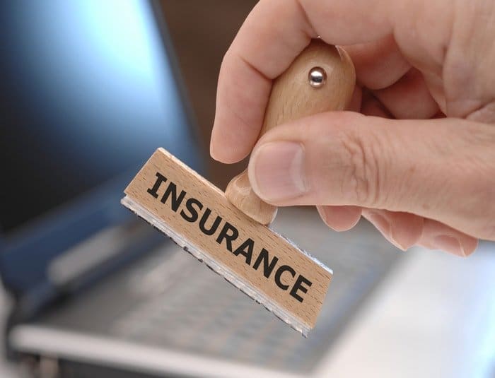 A man holding a stamp with the word "insurance"