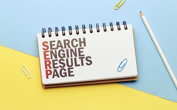 A notepad with the words Search Engine Results Page