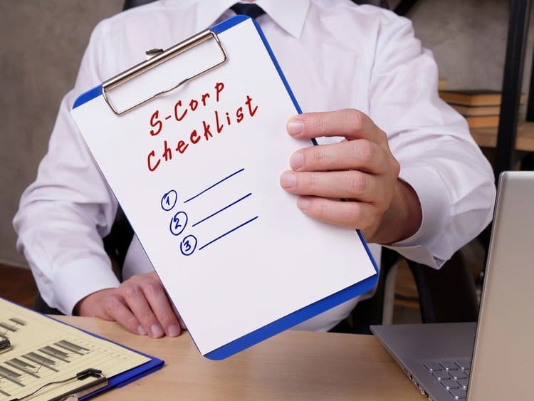 A man holding an S-Corp checklist