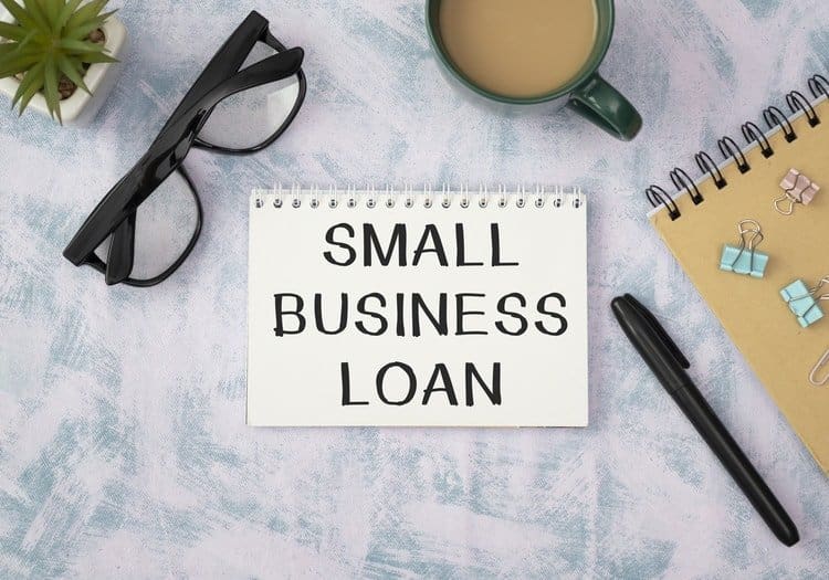A white notebook and a cup of on a desk