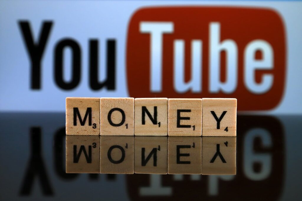 Youtube logo with money word on scrabble tiles 