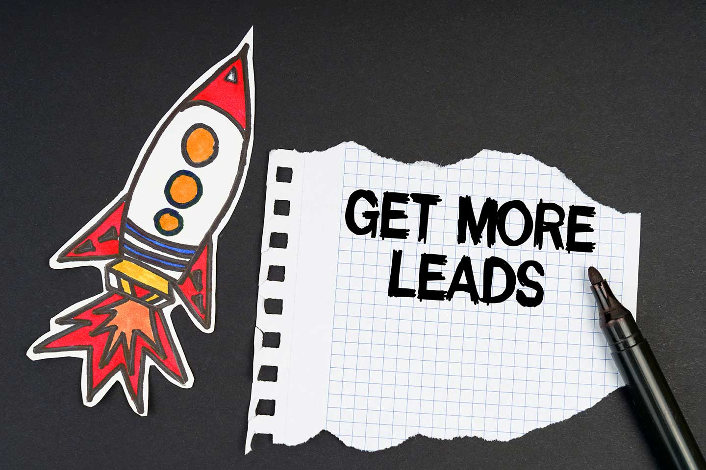 a rocket, a marker and paper with the inscription - get more leads