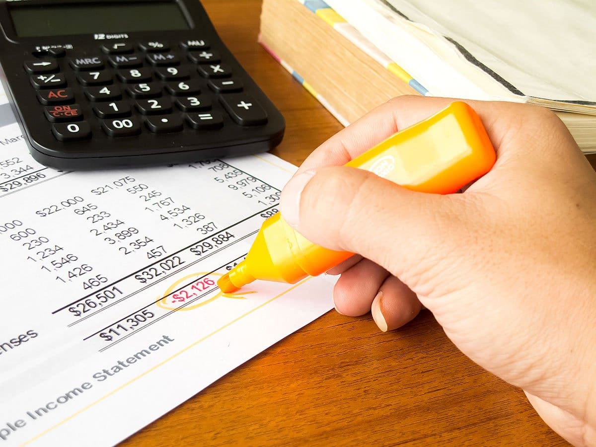 income statement, calculator and a marker