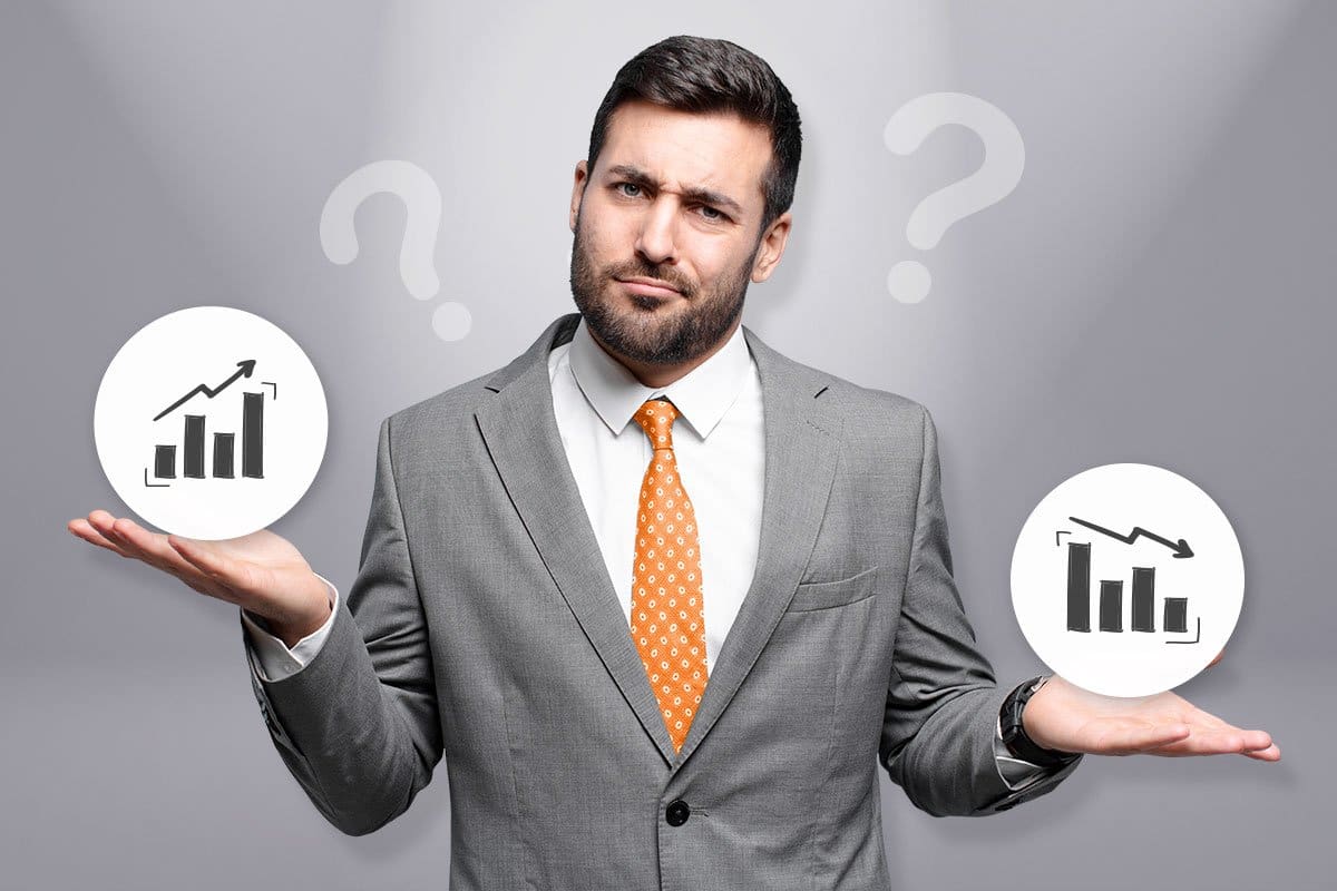 businessman holding an arrow chart up and down icon