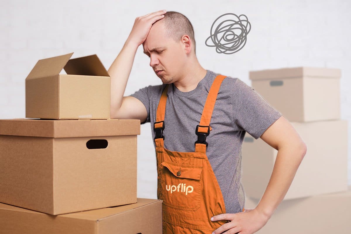 A frustrated man standing beside the packaging boxes
