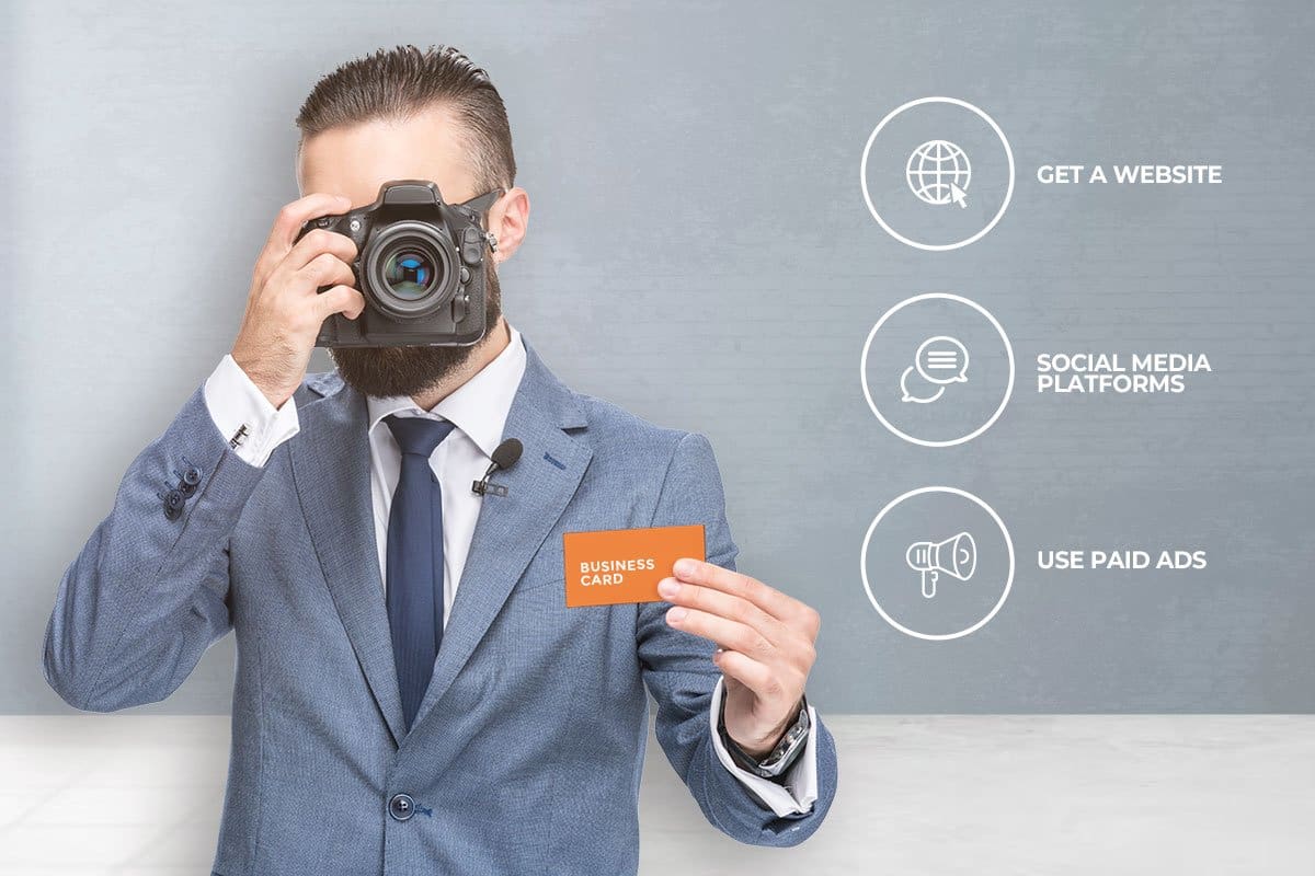businessman holding a camera and a business card