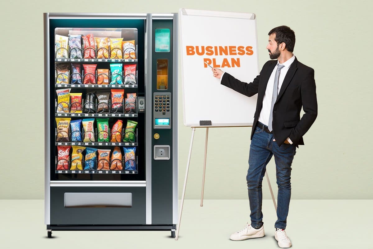Smartly dressed man pointing to whiteboard with words "business plan" in front of a well-stocked vending machine
