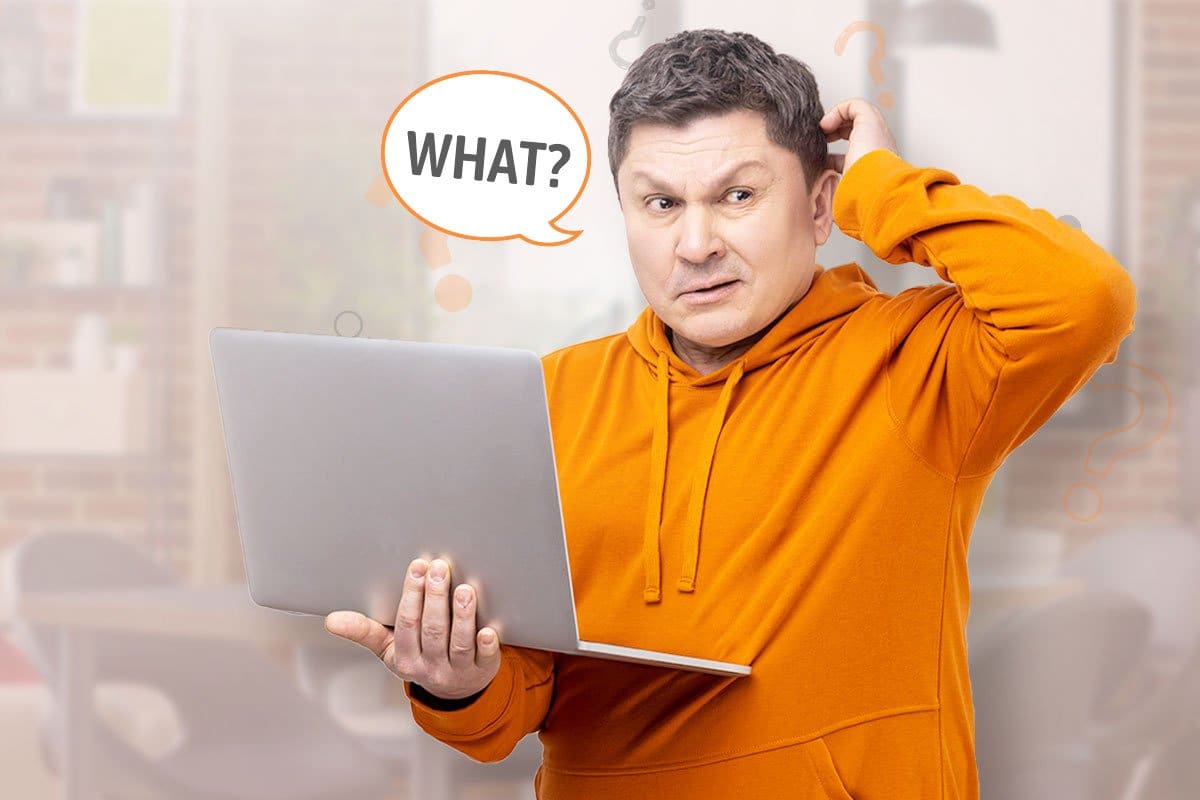 Man in an orange hoodie holding a laptop and wondering about affiliate marketing mistakes, shown with speech bubble reading "What?" overhead