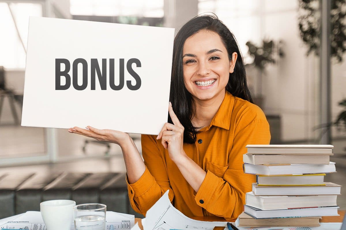 Young woman dressed in business casual holding placard with word "Bonus" for affiliate program partners
