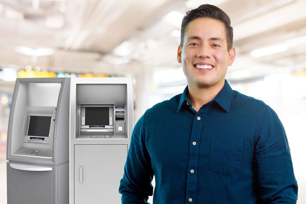How to Start a $15M/Year ATM Business 11 Paul standing in front of ATMs reminding potential owners to consider credit card processing fees