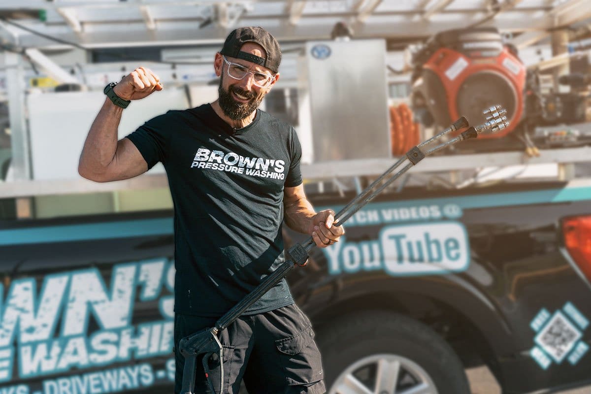 Joshua Brown posing in front of his truck bed pressure washing setup