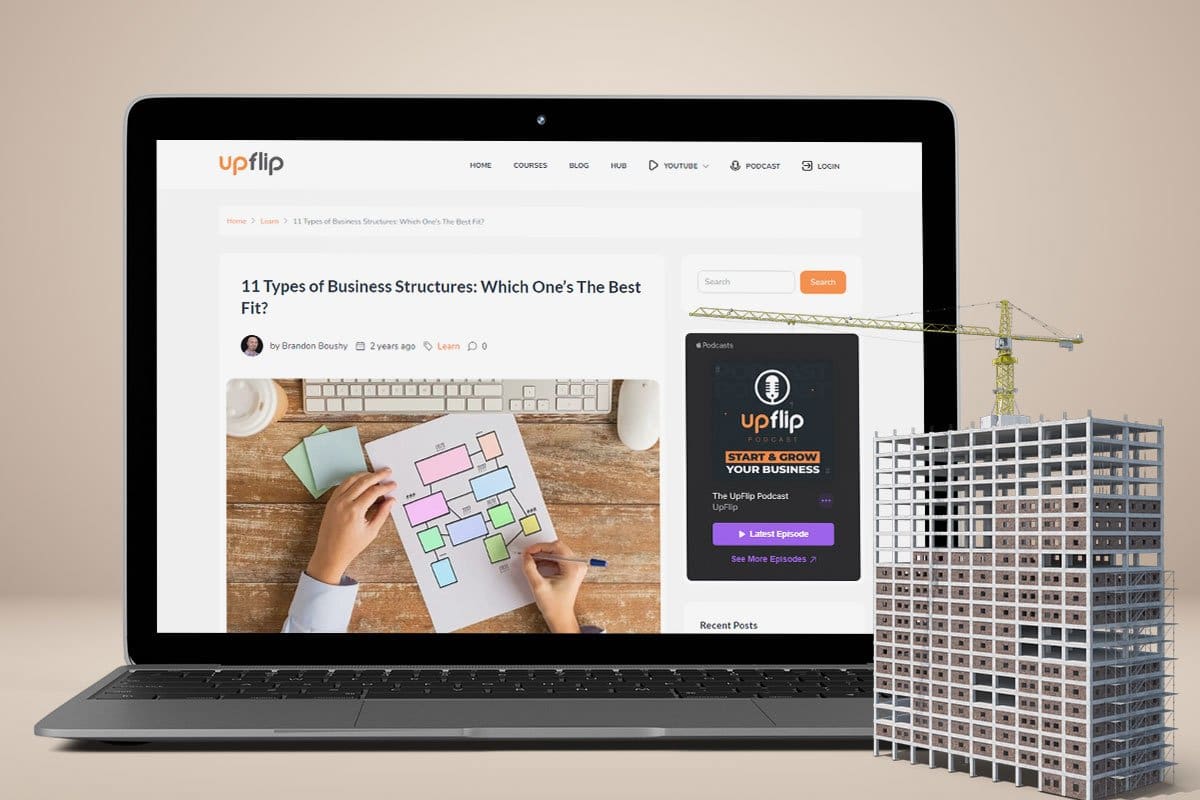 Choosing a business structure for tax benefits with the help of UpFlip’s business structure blog, shown on a laptop with a high rise and crane in the foreground