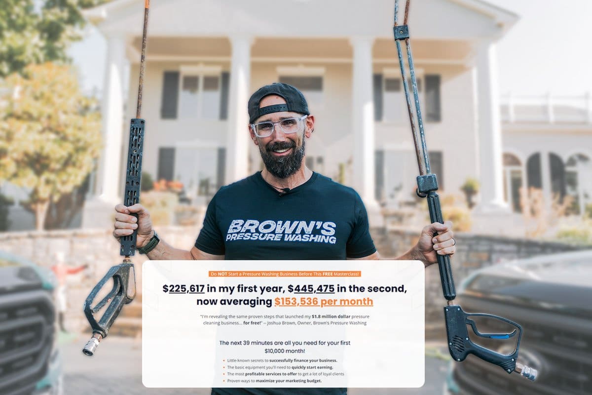 Brown’s Pressure Washing owner standing in front of a large colonial-style home holding pressure washing equipment