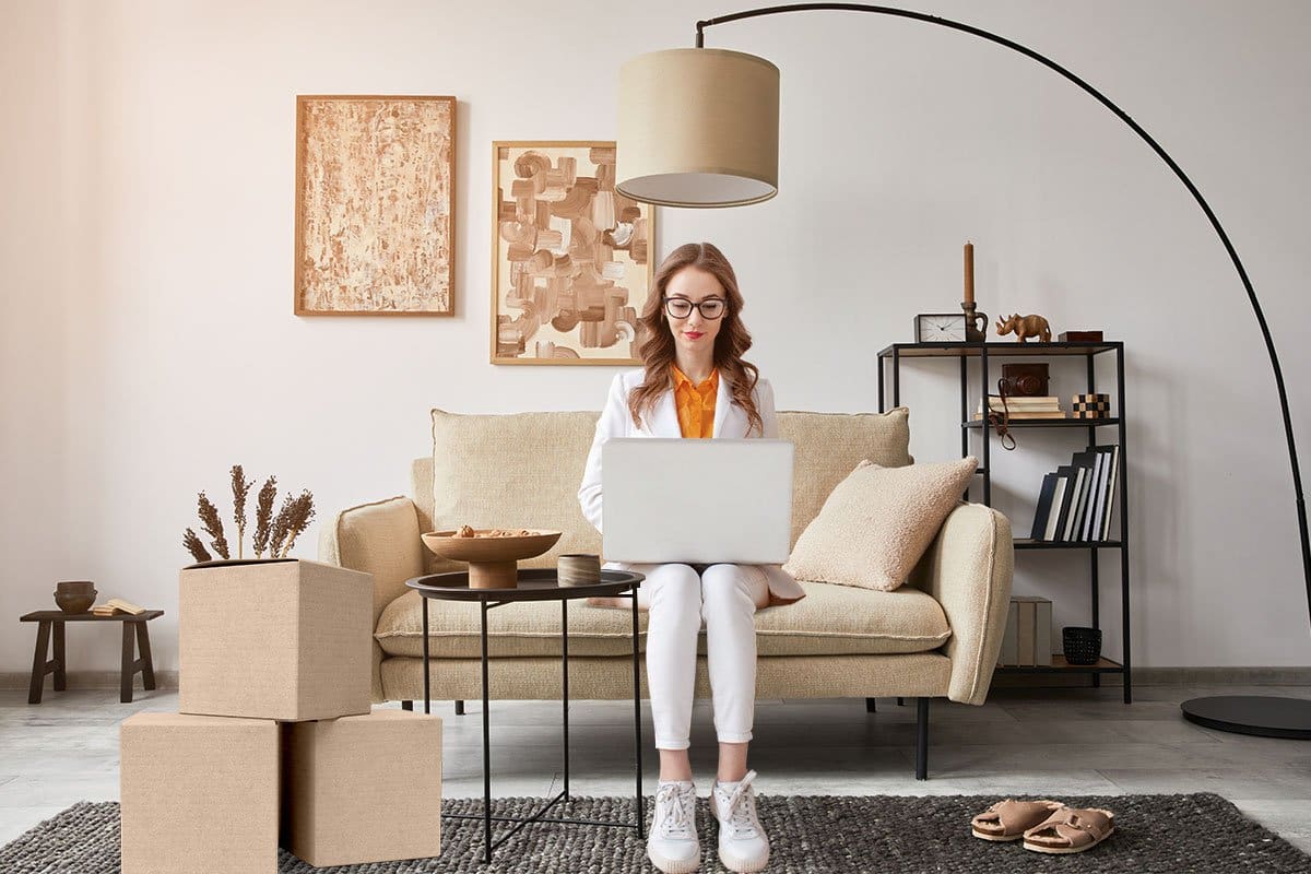 23 eCommerce Business Ideas You Can Start Today 3 Work-from-home entrepreneur sitting in her stylish living room next to a stack of boxes