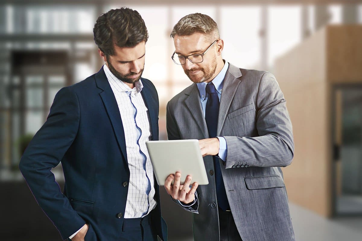 Business owner and a consultant reviewing information on a tablet