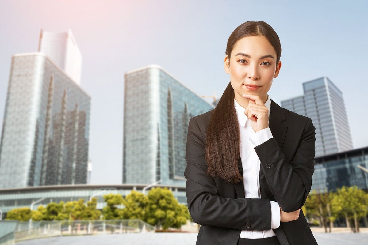 Smartly dressed business woman standing in front of a cityscape