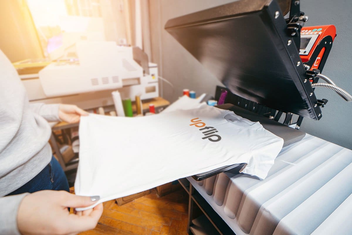 The 11 Best Print-on-Demand Companies of 2025 1 Custom UpFlip t-shirt on a press