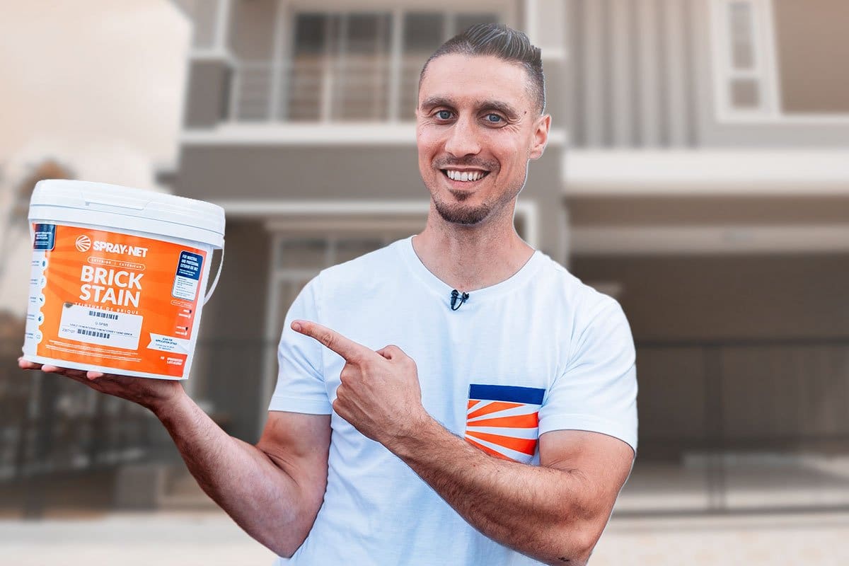 Spray-Net owner pointing to a bucket of brick stain