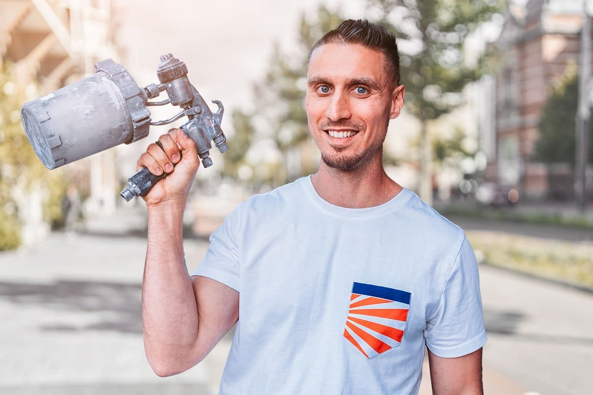 Spray-Net owner standing on a residential street holding a power tool