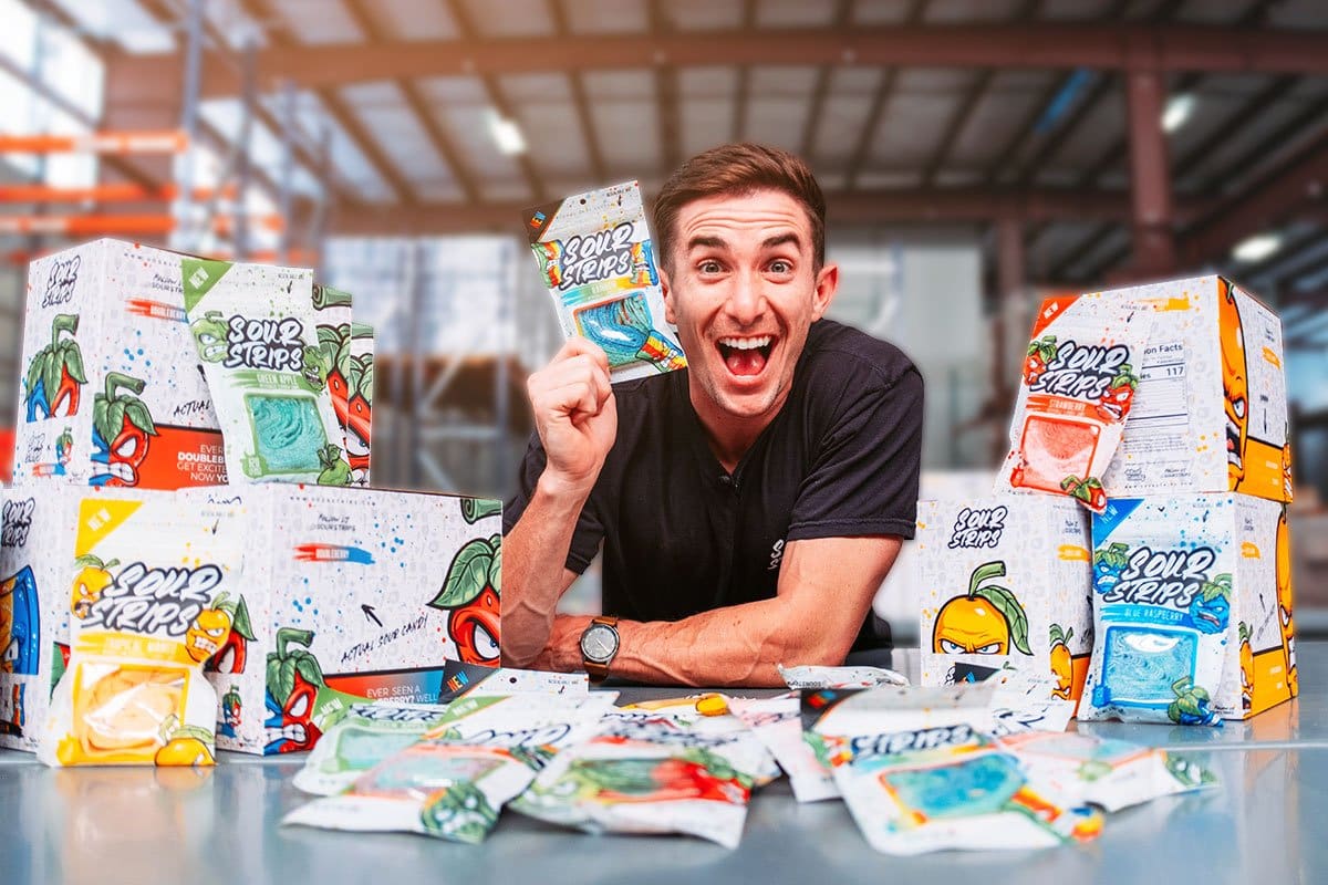 610 Candy Company Name Ideas 3 Sour Strips owner at a table covered with bags and boxes of Sour Strips