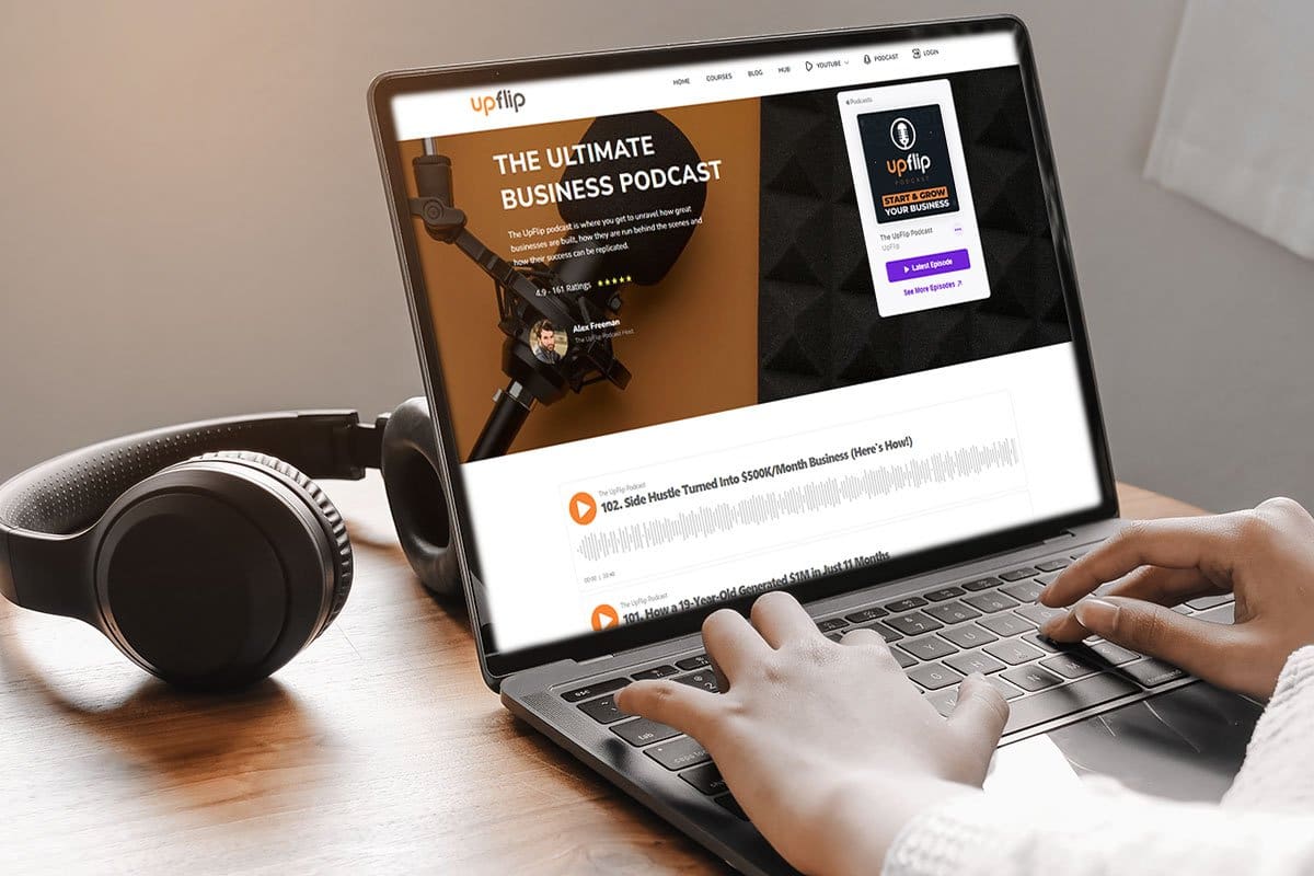 How to Grow a Podcast (2025) 4 Person skimming UpFlip podcast page on a laptop next to over-ear headphones