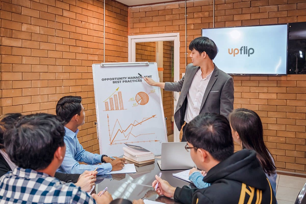 Team learning about opportunity management in a small meeting room