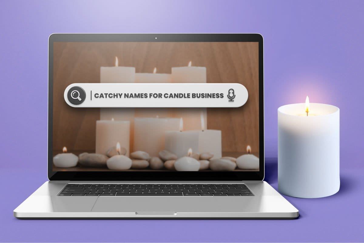 "Catchy names for candle business" search on a laptop next to a white pillar candle