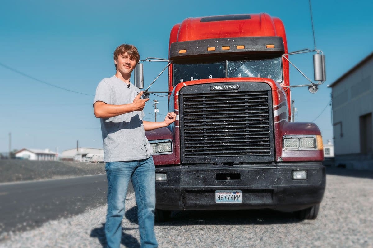 200 Trucking Company Names for 2025 5 Mikael Sant playfully gesturing to his red Freightliner truck
