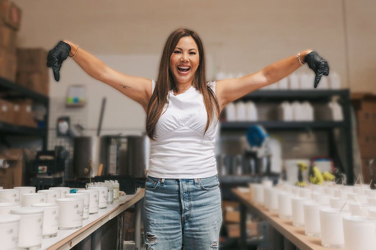 520 Candle Company Names (for 2025) 6 Rx Los Angeles owner in her warehouse pointing to two tables of empty branded jars and just-poured candles