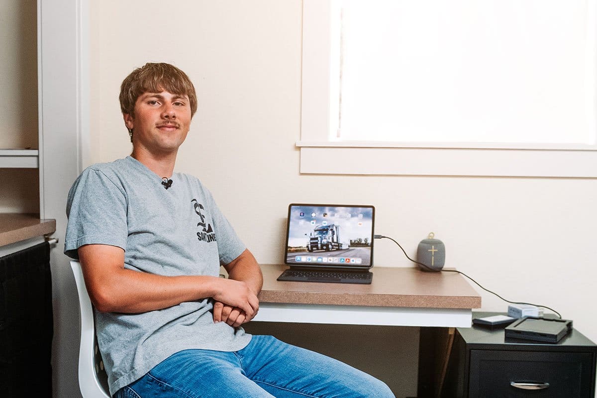 Mikael Sant sitting in a modest office space 