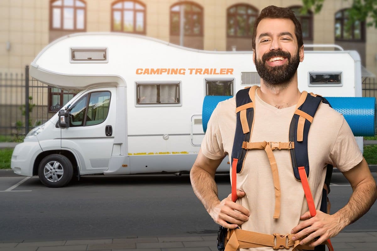 Camping guide wearing a day pack in front of an RV rental