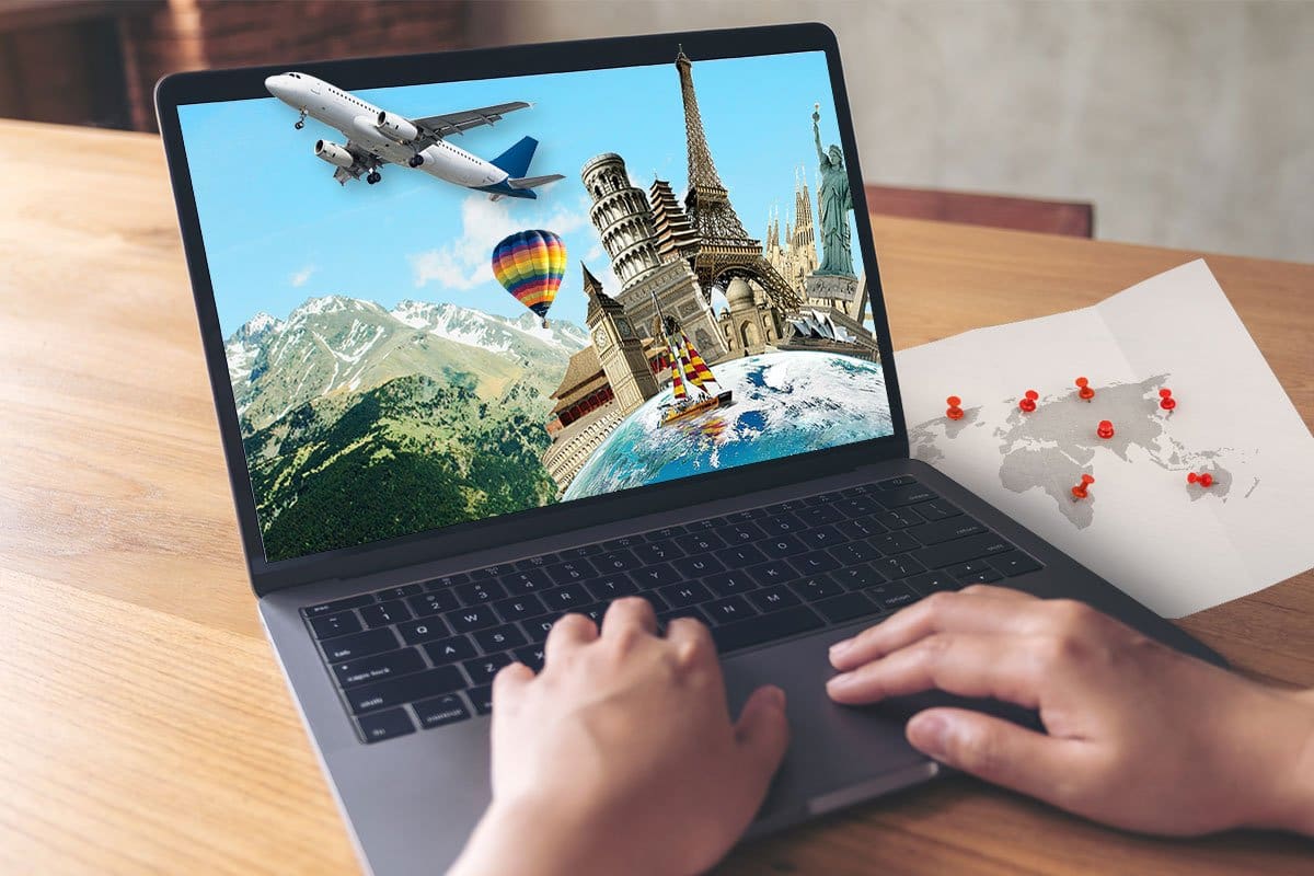 338 Eye-Catching Travel Agency Names 4 Travel agent working on their laptop