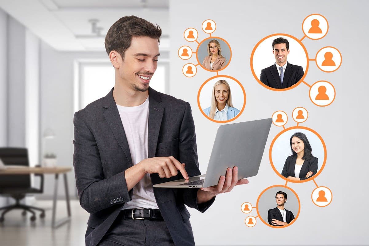 Concept of an online mastermind group showing a man using a laptop and headshots of his mastermind group members hovering around it