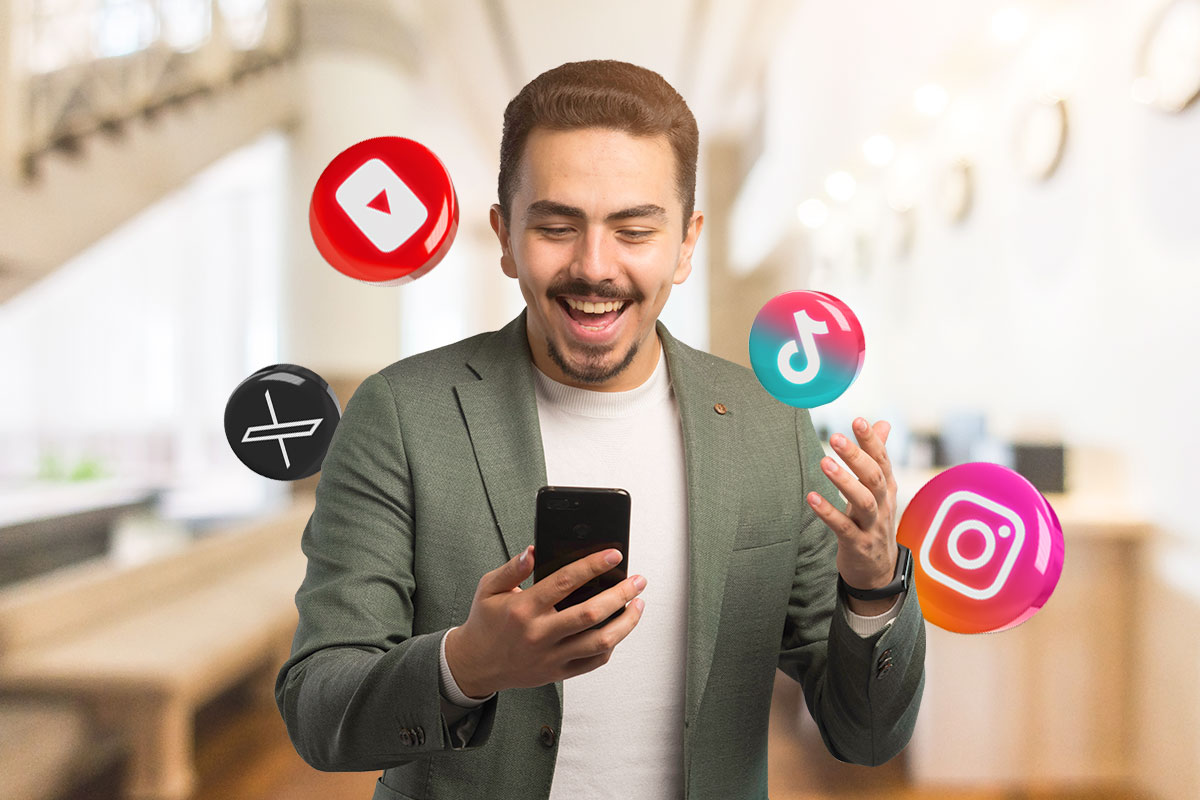 Man excitedly checking a smart phone as social media icons for X, YouTube, TikTok, and Instagram hover around him.
