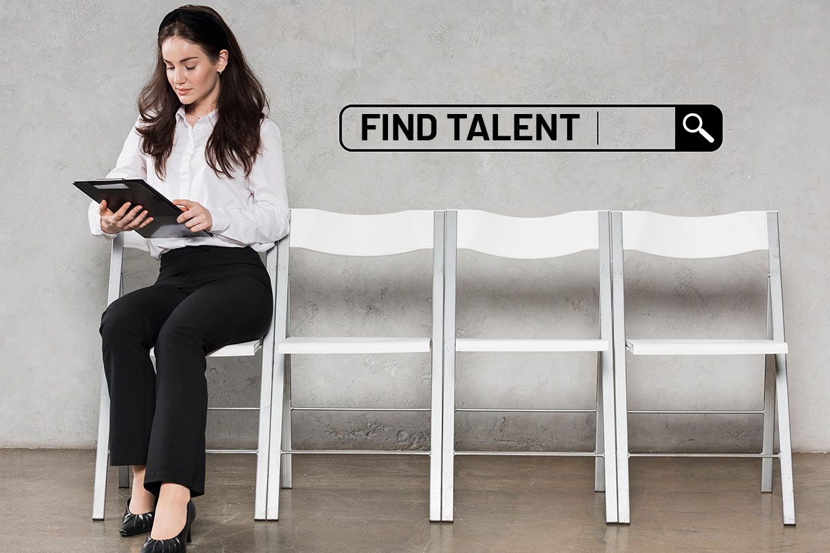 How to Start a $2.88M/Year Recruiting Business 4 A sharply dressed woman sitting in a minimalist space using a tablet to run a talent search