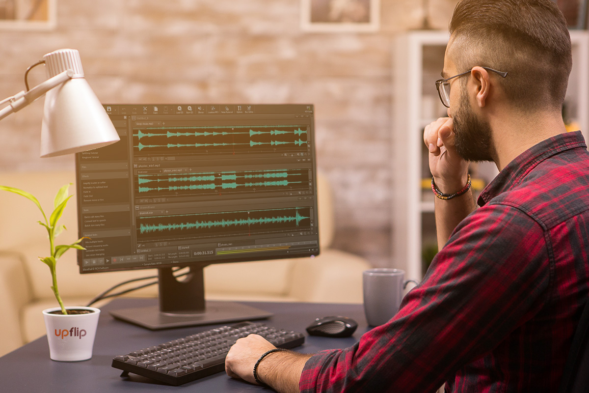 How to Start a Podcast: The Ultimate Guide (2025) 15 man working on adobe audition software on a computer