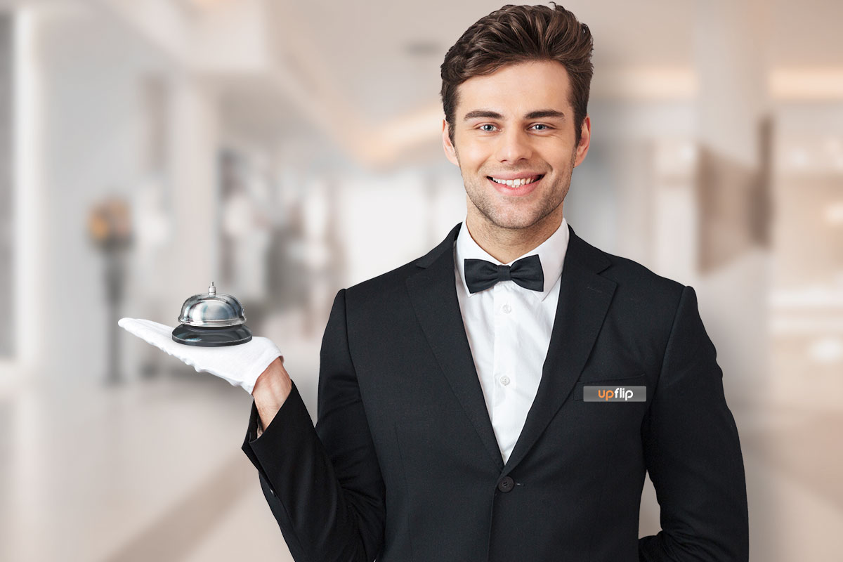 The 25 Best Low-Cost Business Ideas (for 2025) 23 Smiling personal concierge dressed in a tux and holding a bell in the palm of his hand