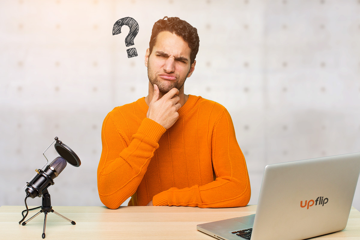 How to Start a Podcast: The Ultimate Guide (2025) 3 man in an orange shirt sitting in front of a laptop