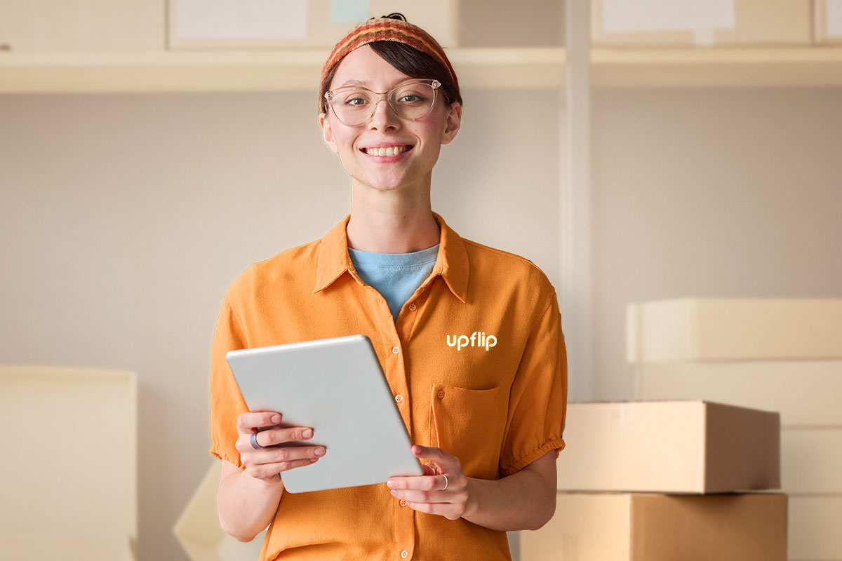 The 25 Best Low-Cost Business Ideas (for 2025) 8 Woman working on a tablet with boxes in the background