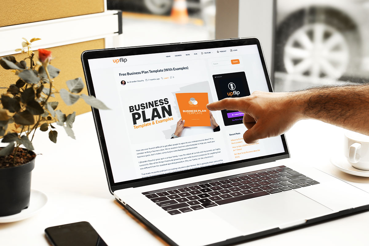 hand pointing on a laptop on the table