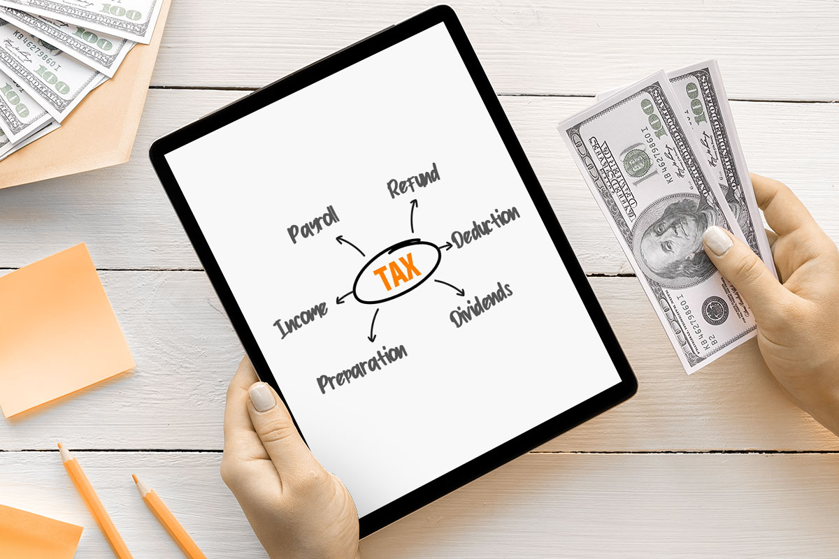 woman holding a tablet and a cash