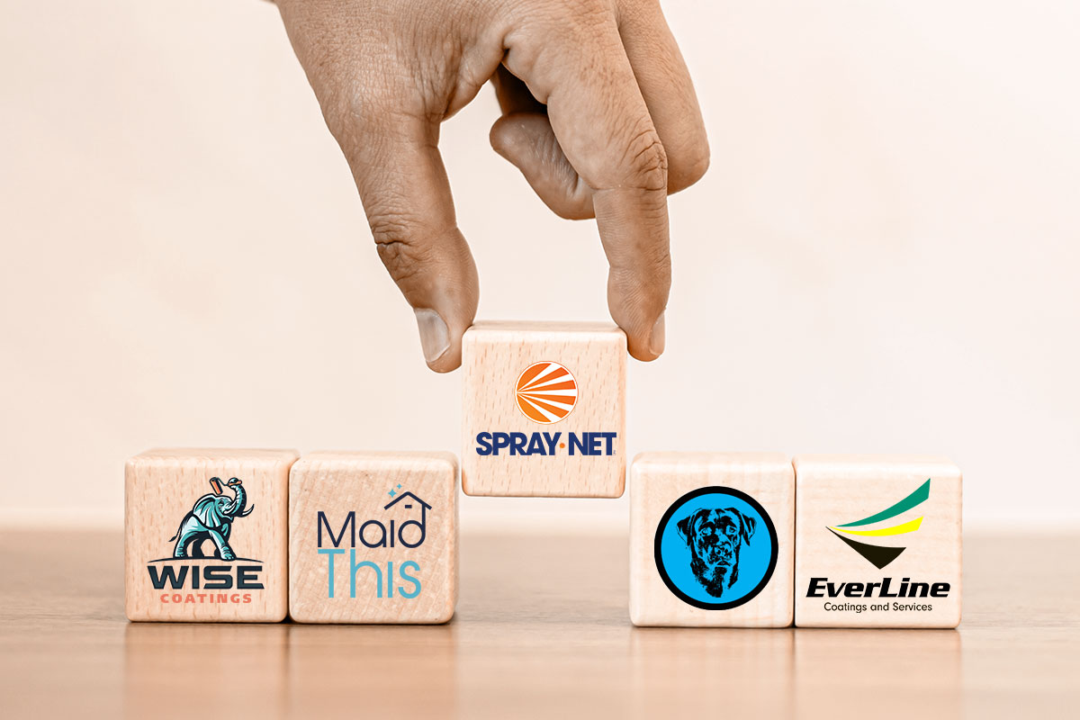 Human hand picking a wooden block with company logos