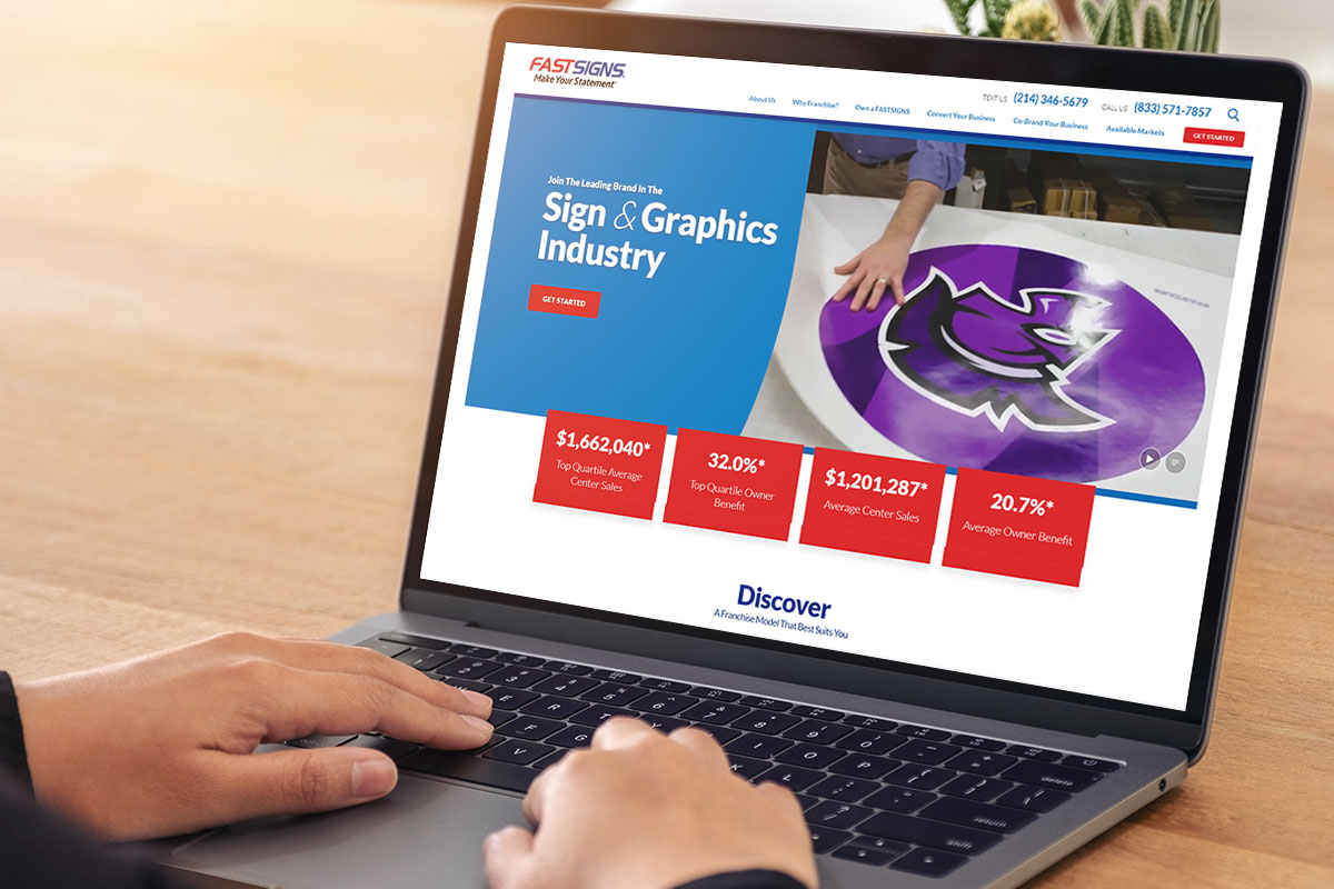 Laptop open to the FastSigns website