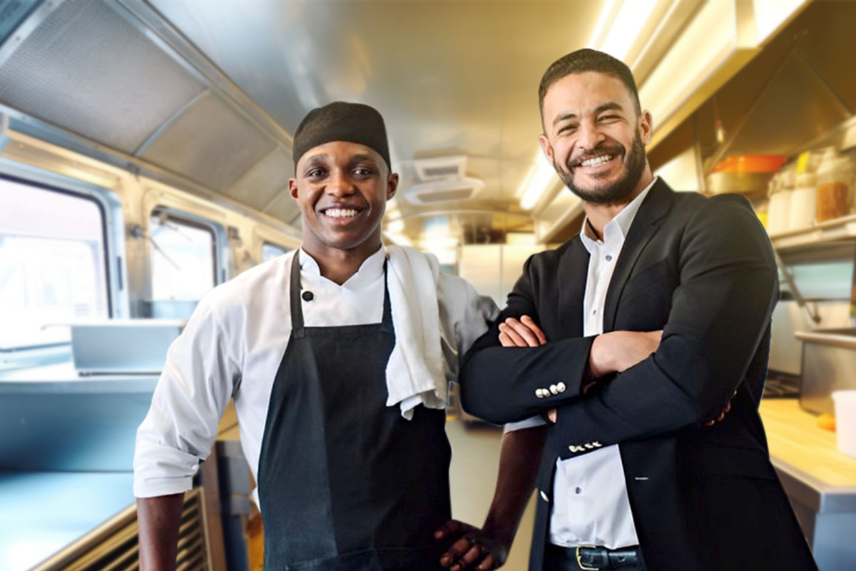 Food truck owners posing inside food truck