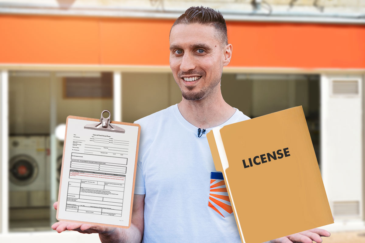 Best Laundromat Franchises of 2025 13 Laundromat owner holding a copy of a business license and paperwork