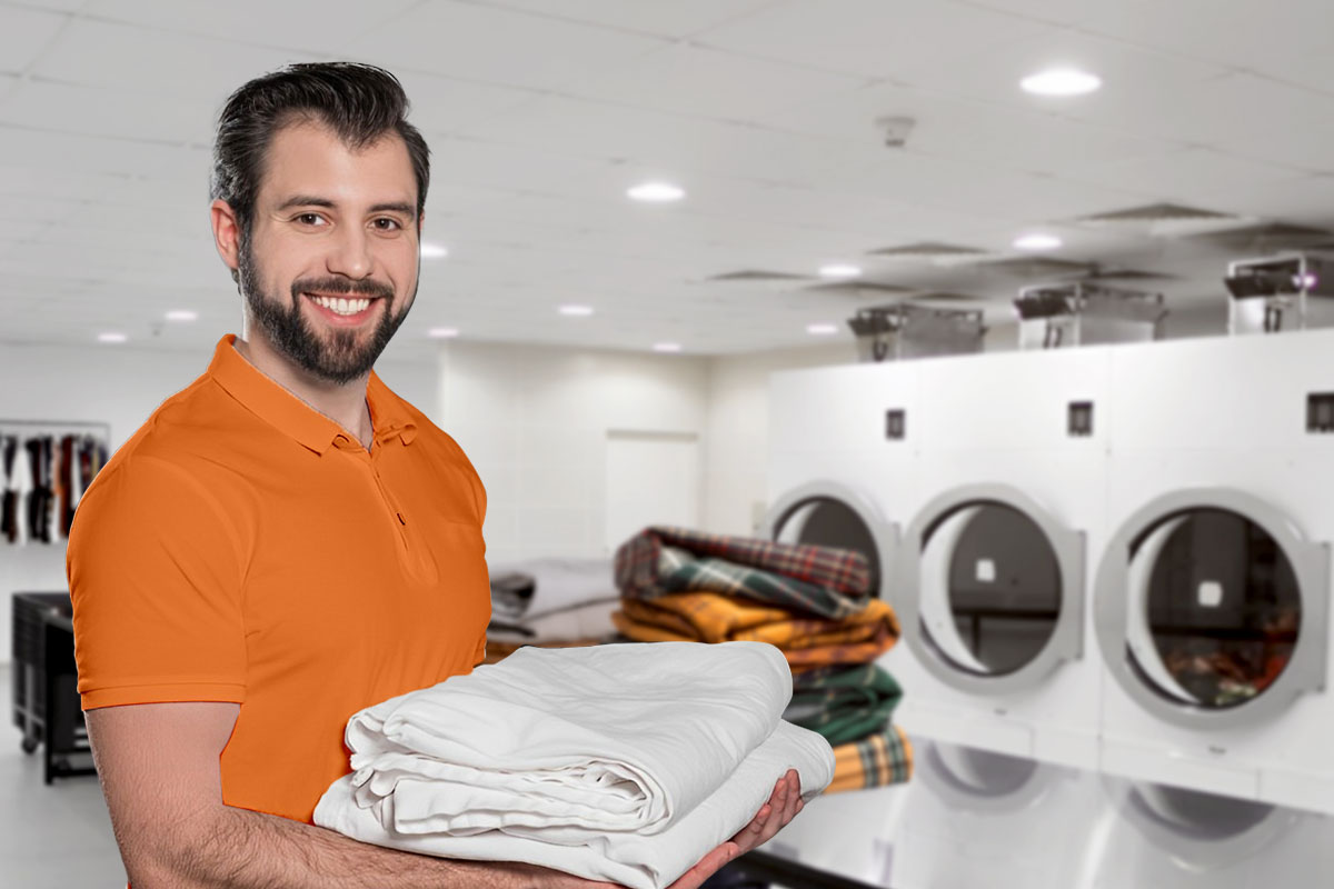 Best Laundromat Franchises of 2025 1 Customer holding folded laundry inside a laundromat