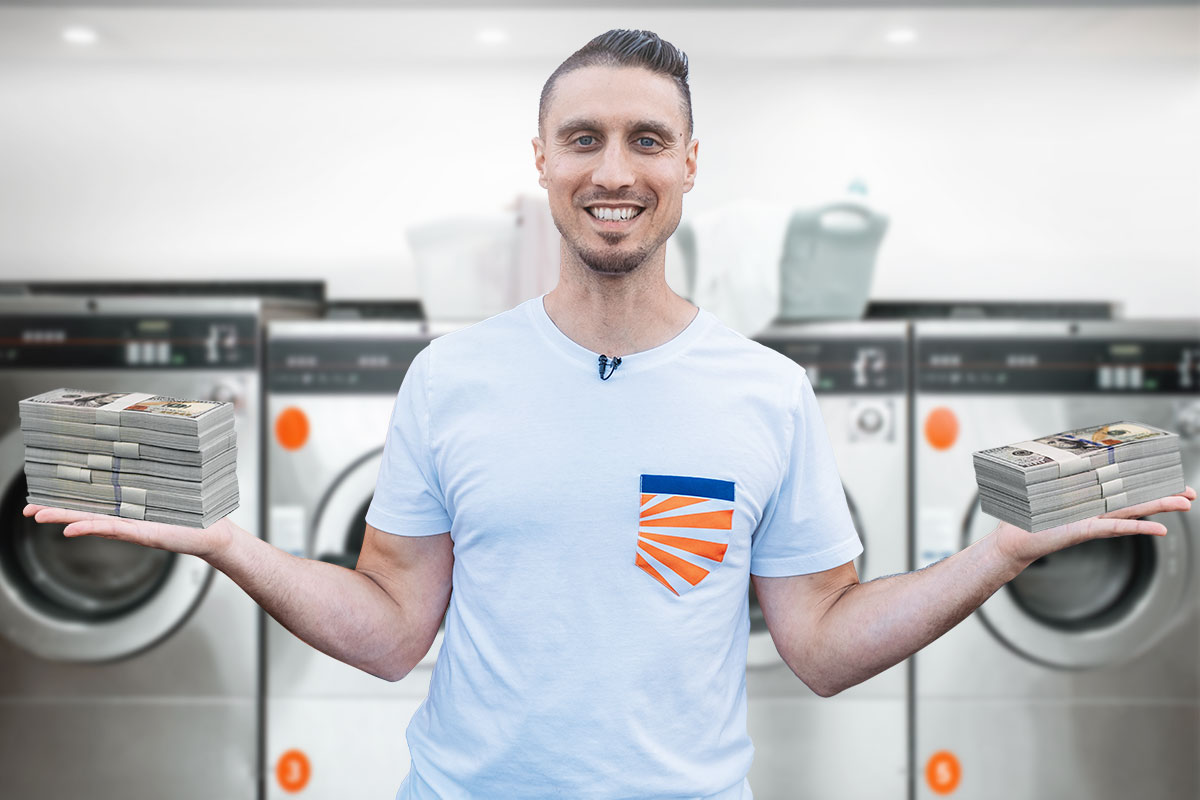 Best Laundromat Franchises of 2025 8 Laundromat owner holding stacks of money standing in front of a row of washers and dryers