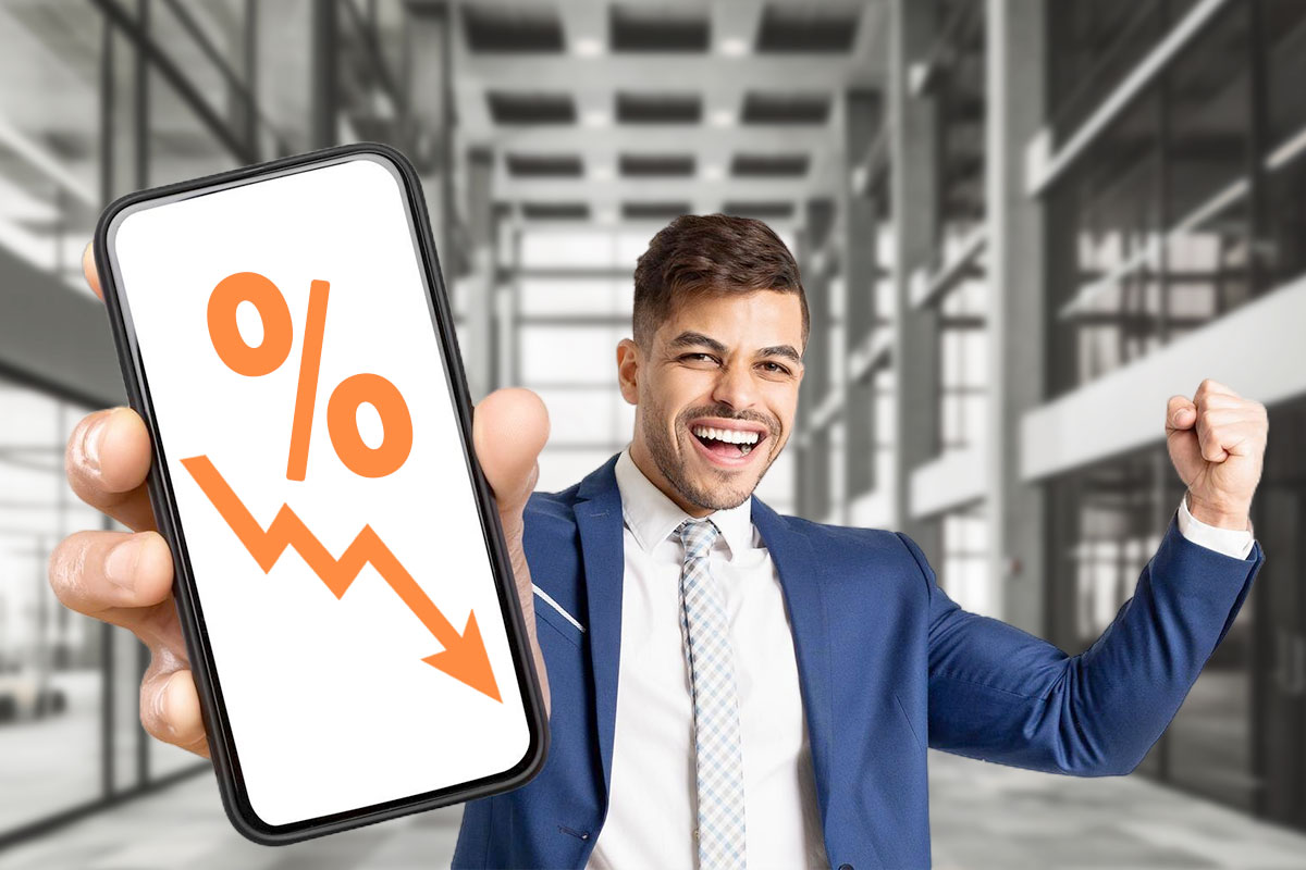 Best Laundromat Franchises of 2025 10 Happy business owner holding a phone with a graph that represents a low rate of failure