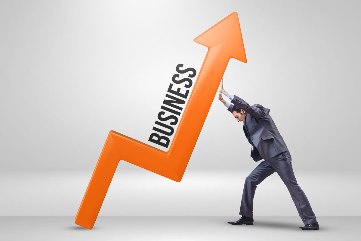Business owner supporting a giant arrow pointing up with the label "business"
